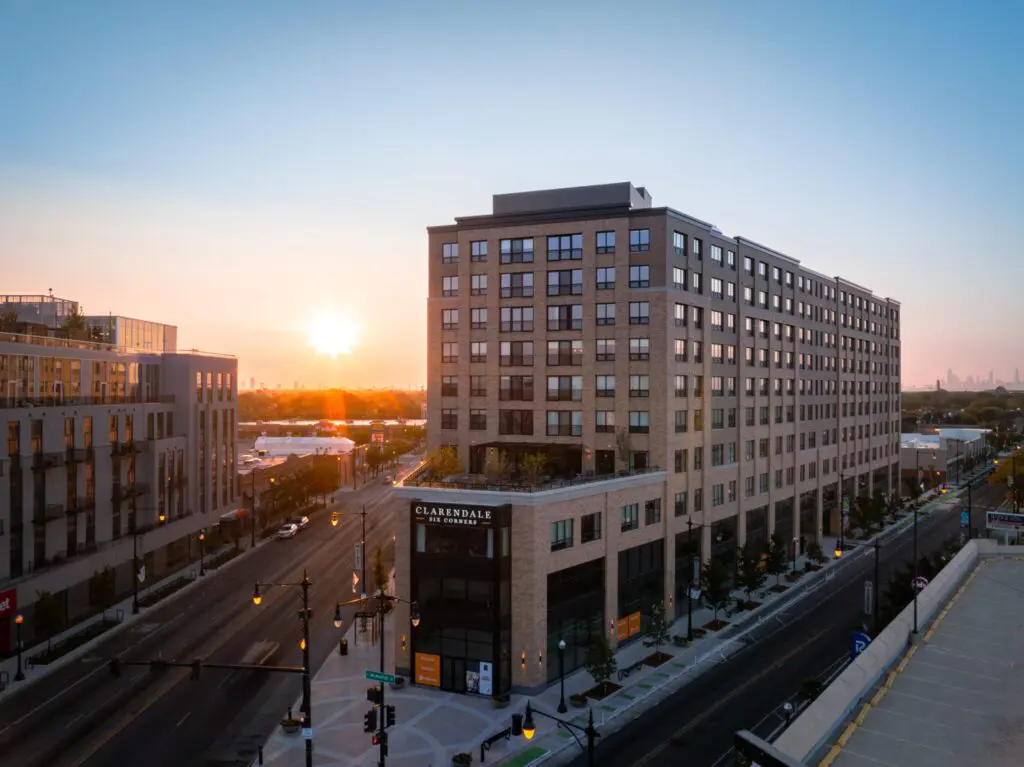 Ever wonder how much does memory care cost? Come find out today. This image features an aerial shot of Clarendale Six Corner at dusk.