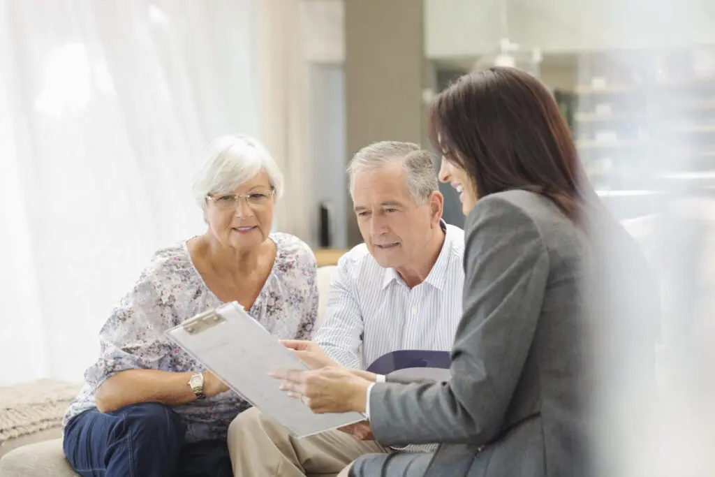 seniors reviewing paperwork on how much does memory care cost at Clarendale Six Corners in Chicago, IL.