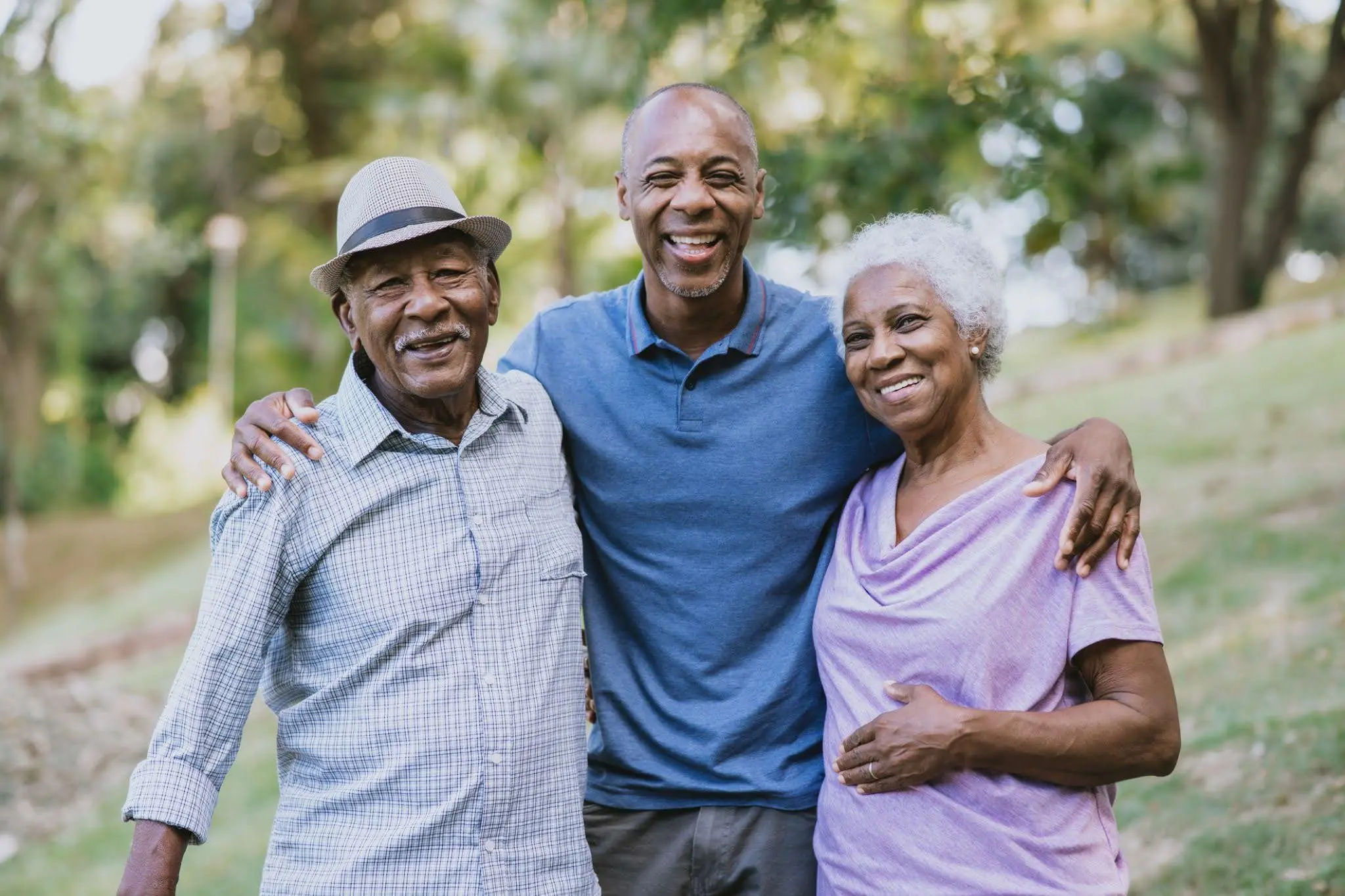 An adult son hugging his senior parents after helping them with choosing a senior living community like Clarendale Six Corners.