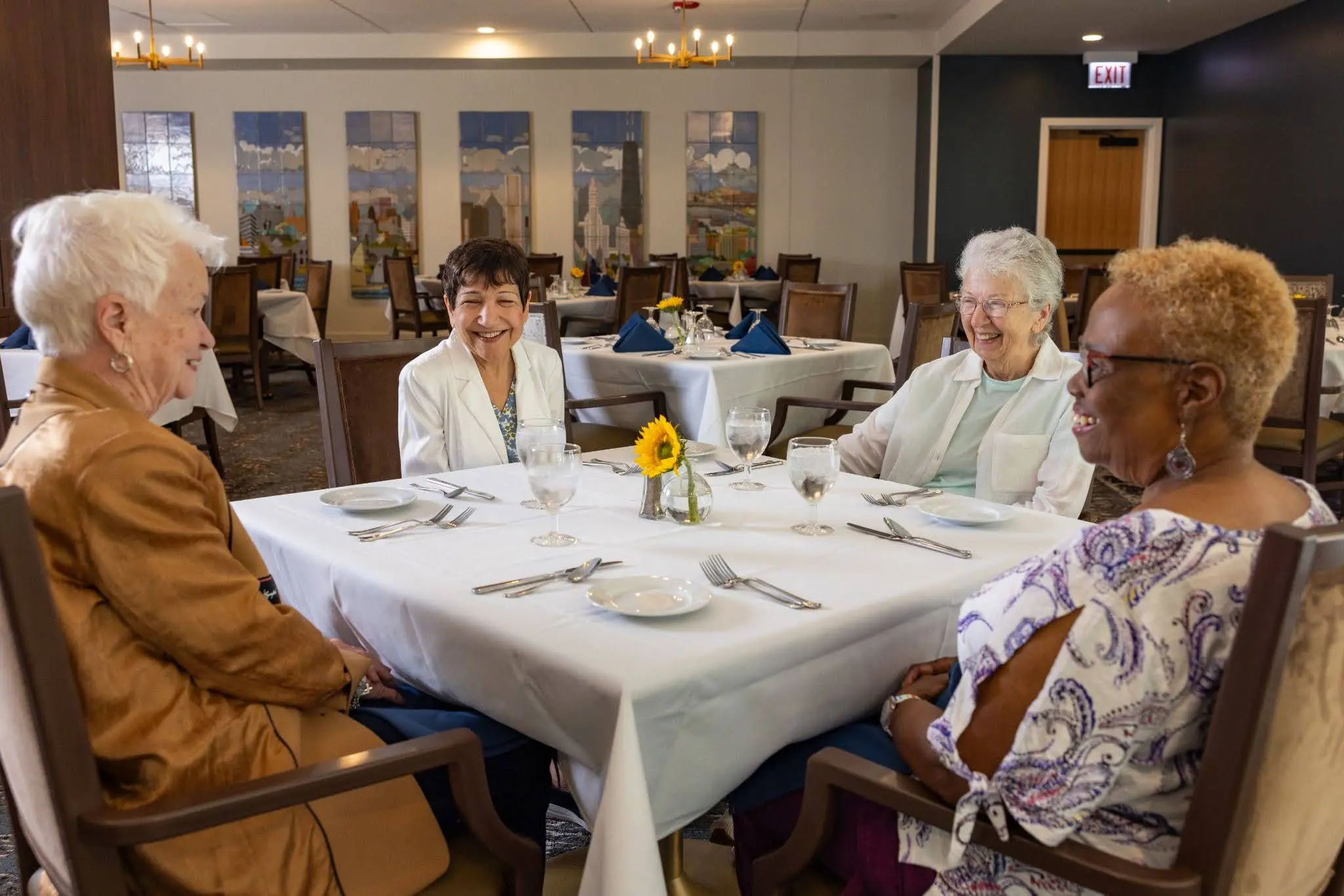 Residents of Clarendale Six Corners, an up scale senior living community in Chicago, IL dining an living a maintenance-free living retirement.
