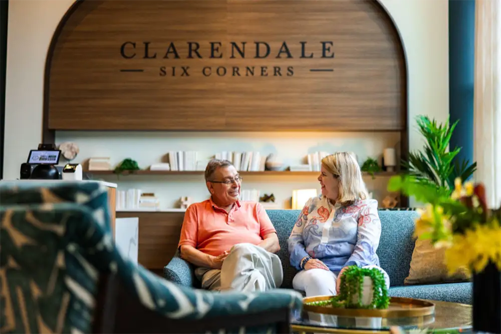 Man and woman having a conversation in the lobby of Six Corners.