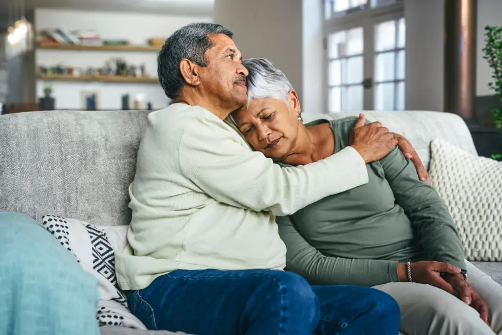 a senior man comforting his wife