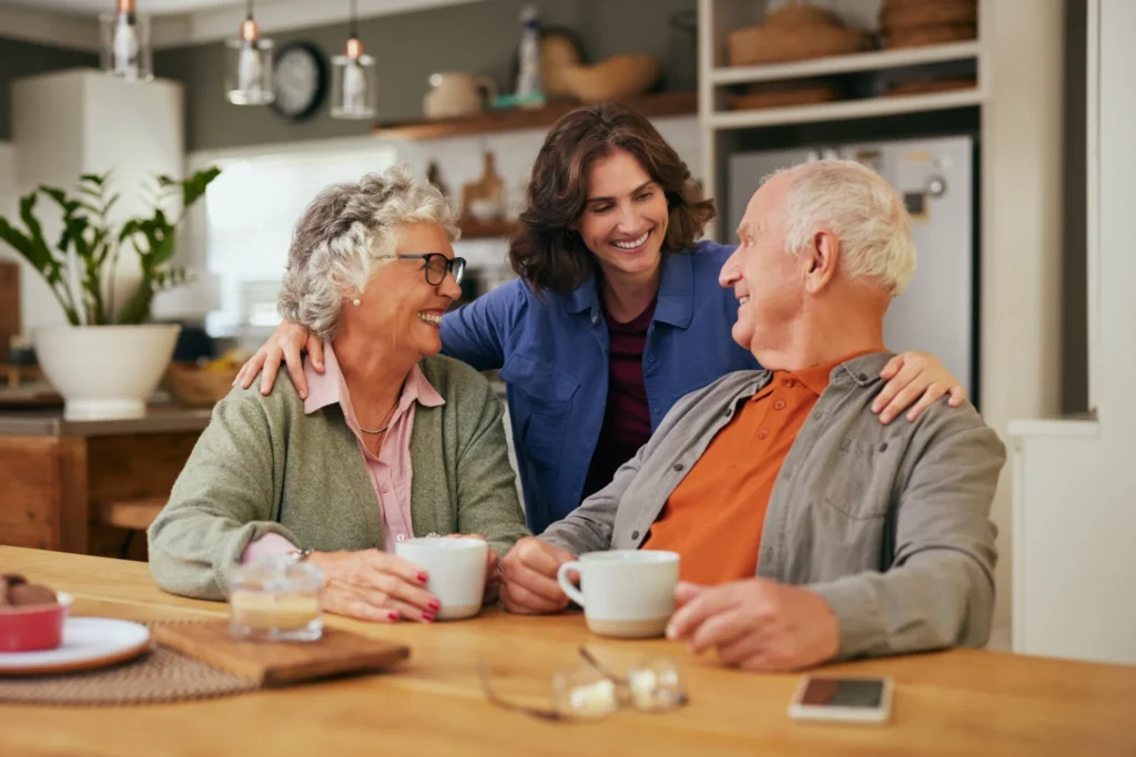 An adult woman hugging her seniors parents and talking about questions to ask assisted living communities in Chicago, IL like Clarendale Six Corners.