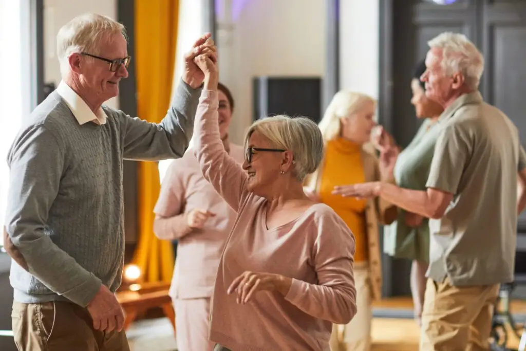 Senior people dancing at Clarendale Six Corners, a senior living community in IL.