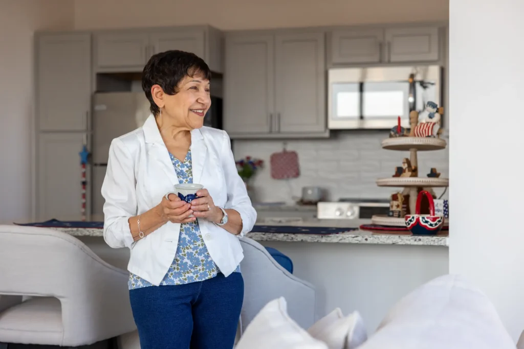 senior woman smiling because she's read the top books on aging well from her home at Clarendale Six Corners in Chicago, Illinois.