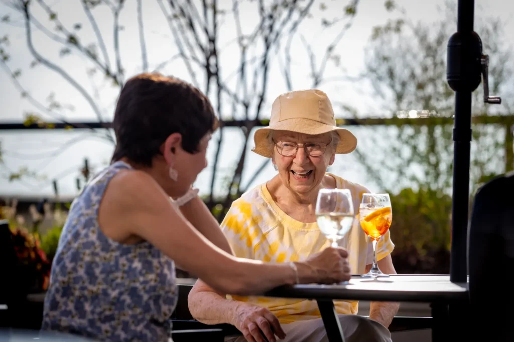 senior women sitting outside at Clarendale Six Corners talking about moving to independent living in Chicago, Illinois